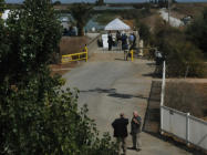 People walk along a levee between diked baylands