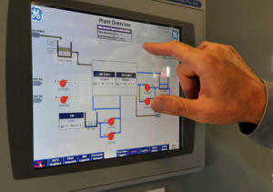 Gary Wettstein checks a process logic control panel 